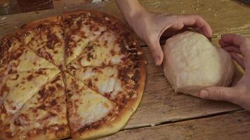 Couple in love are making pizza out of dough. They join their hands together in way that forms heart, symbolizing their love for baking and cooking. video