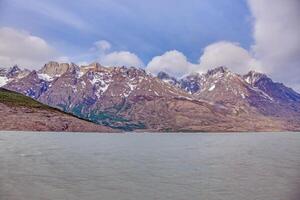 Distant view of Grey Glacier flowing into Lago Grey surrounded by mountains in Torres del Paine h photo