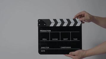 hand holding empty film slate and clapping in front of camera video