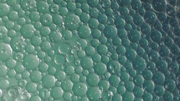 Oil bubbles movement abstract background. A motion of clear oil bubbles floating in colors liquid. Relaxing and artistic visual experience background. symbolizing fluidity science from oil and water. video