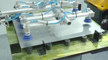 Automated robotic arm system with suction cups and pneumatic tubing used for industrial material handling. Demonstrates advanced automation for lifting positioning and assembly operations in factories video