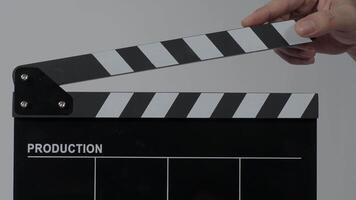 Close up hand holding empty film slate and clapping in front of cameras video