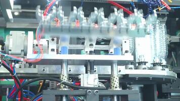 Demo making of PET. drinking water plastic bottle such as PET preform before automate heat blowing and shaping in molding machine and other process of making plastic bottles. Drinking water industry video