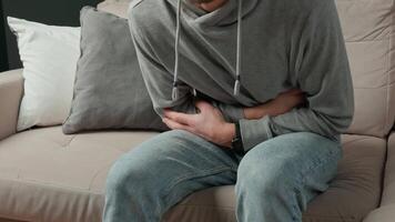 Man clutching stomach in pain. Person suffering from digestion problems video