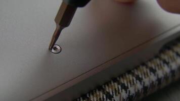 Man unscrews screw with small torx screwdriver. Assembly and disassembly of furniture. The wizard tool. Close up. video