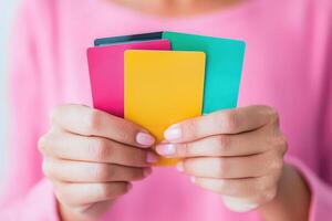 A close-up of a person holding colorful credit cards, showcasing modern payment methods in a stylish way. photo