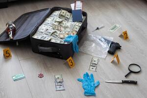 an old black suitcase with an open lid full of one hundred dollar bills. Corruption photo
