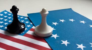USA flag and EU flag print screen on two pawn chess for battle.It is symbol of United States of America increase tariff tax barrier for import product from EU countries.-Image. photo