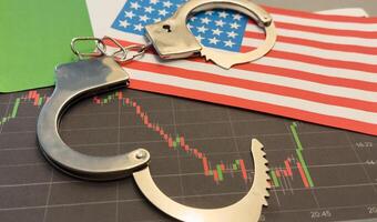 top view handcuffs against the background of charts and hundred-dollar bills photo