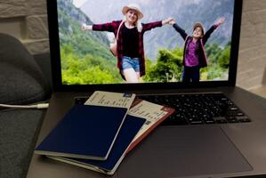 a passport on laptop computer keyboard. Online travel booking and visa application. photo