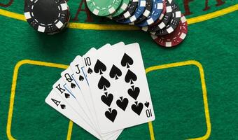 A popular and exciting poker game with a winning combination. Playing cards and chips on a table in a poker club. Advertising space. photo