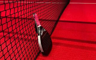 Padel tennis racket. Background with copy space. Sport court and balls. photo