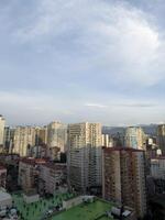 View of old district of Batumi in Georgia from window. High view of residential area of Batumi with old houses and mountains in background. Vertical photograph of the cityscape photo