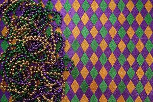 Mardi Gras Beads and Diamonds. Colorful beads and harlequin background photo