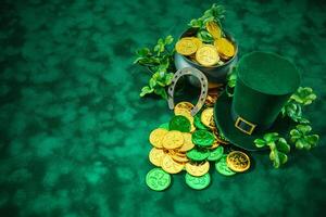 St. Patrick's Day Symbols. A festive setup with a pot of gold, leprechaun hat, horseshoe, and shamrocks photo