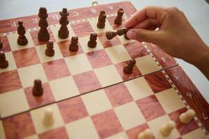Person engaging in an intense strategic chess match photo