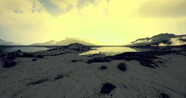 Stunning view of a tranquil lake surrounded by mountains at dusk video