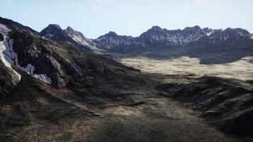 A view of a mountain range from the top of a hill video