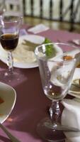 remnants of meat dishes and snacks are on the festive table after the feast. Camera motion to the right. Blurred background Vertical video