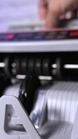 Electronic machine counting hundred dollar bills. Modern automatic equipment for counting paper currency. Money counting machine for banking and commercial activity. Slow motion. Vertical video