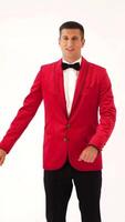 funny man in red suit is making funny movement with his hands and body on a white background in the studio. Fool around Vertical video