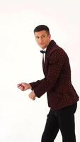 charismatic man in a brown suit is showing a typical golf player on the field. Parody in the studio Vertical video