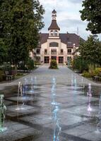 Mikhailowo, Poland, 08.18. 2024. Central city park, fountain, town hall photo