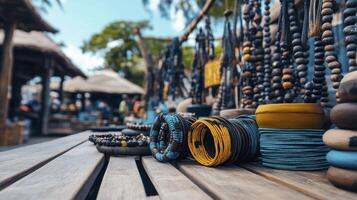 Colorful handmade jewelry displayed on a wooden table at a vibrant outdoor market with blurred background photo