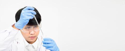 Asian male student scientist reagent mixing laboratory In a science research laboratory with test tubes of various sizes and microscopes. on the table in laboratory chemistry lab white background photo