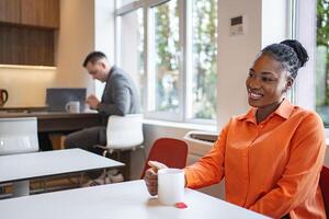 Woman Sitting at Table With Coffee Cup photo