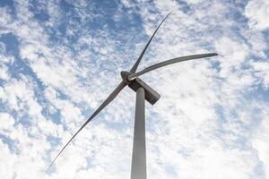 One white wind generator produces alternative energy by wind on the fields in Europe in Spain photo