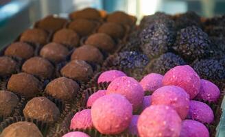 multi-colored chocolate and iced candies of different colors and shapes are neatly stacked in their places. High quality photo
