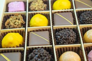 multi-colored chocolate and iced candies of different colors and shapes are neatly stacked in their places. High quality photo