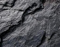 Close-up of Black Rock Surface with Natural Patterns photo