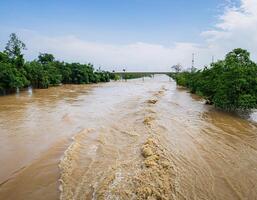 Powerful River Current Overflowing, Creating Dangerous Flood Conditions photo