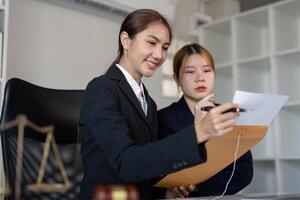 Lawyer explaining legal documents to a client in an office with a gavel on the desk. photo