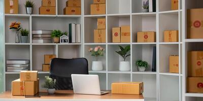 Organized home office with packages for online sales and laptop setup. photo