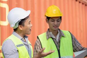 Logistics collaboration between engineers in shipping yard container terminal professional exchange industrial environment close-up perspective photo