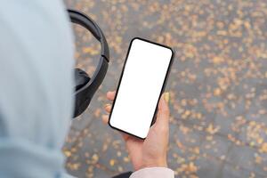 Engaging with technology a person holding a smartphone in a leafy urban environment close-up perspective of lifestyle choices photo