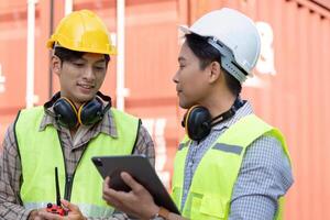 Logistics engineers collaborate on container management warehouse facility image professional environment close-up efficiency concept photo