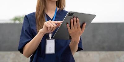 Nurse using a tablet for patient care and documentation during a break photo