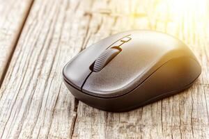 Close-Up of Computer Mouse on Wooden Table Surface with Soft Lighting and Textured Detail photo