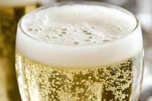 Refreshing Glass of Beer with Bubbling Froth Against a Soft Background and Elegant Waves photo