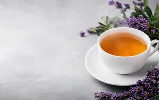 steaming cup of herbal tea surrounded by fresh lavender flowers, promoting relaxation and wellness. This serene scene captures essence of holistic rituals photo