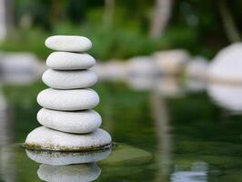serene zen garden featuring stacked stones on calm water, creating peaceful atmosphere. smooth stones reflect tranquility and balance in nature photo