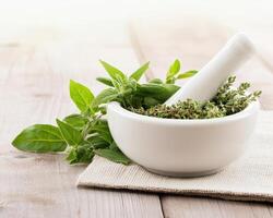 Fresh herbs in mortar and pestle, perfect for culinary use and herbal remedies. vibrant green leaves add natural touch to any kitchen setting photo