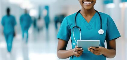 Healthcare worker smiling in clean office, holding tablet, wearing scrubs photo