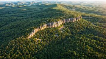 The view from above of a mountain range with trees and green vegetation photo