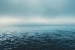 A view of the ocean from above with a foggy sky photo