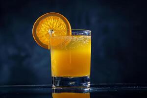 Orange juice with a slice of orange on a dark background photo